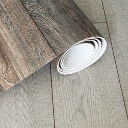 Roll of linoleum with a wood texture. Types of floor coverings. PVC.